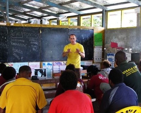A Volunteer Minister of the South Pacific Good Will Tour covers information to improve teacher and student performance at a workshop at Visale Primary School.